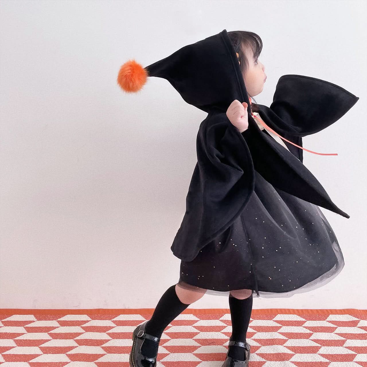 Kids Orange Pompom Cone Cape (0 - 8y) - Black kids outfit