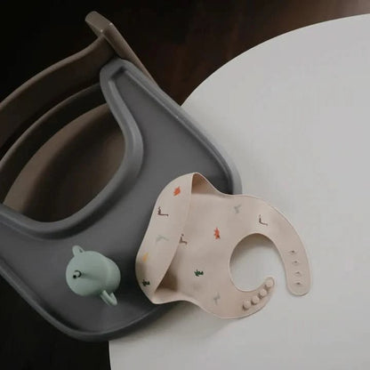 Mushie Silicone Baby Bib - Dinosaurs kids outfit